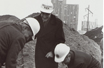 Three men digging during groundbreaking for New Law School