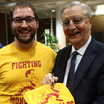 Walter Mondale signing a 'Fighting Mondales' intermural hockey t-shirt.